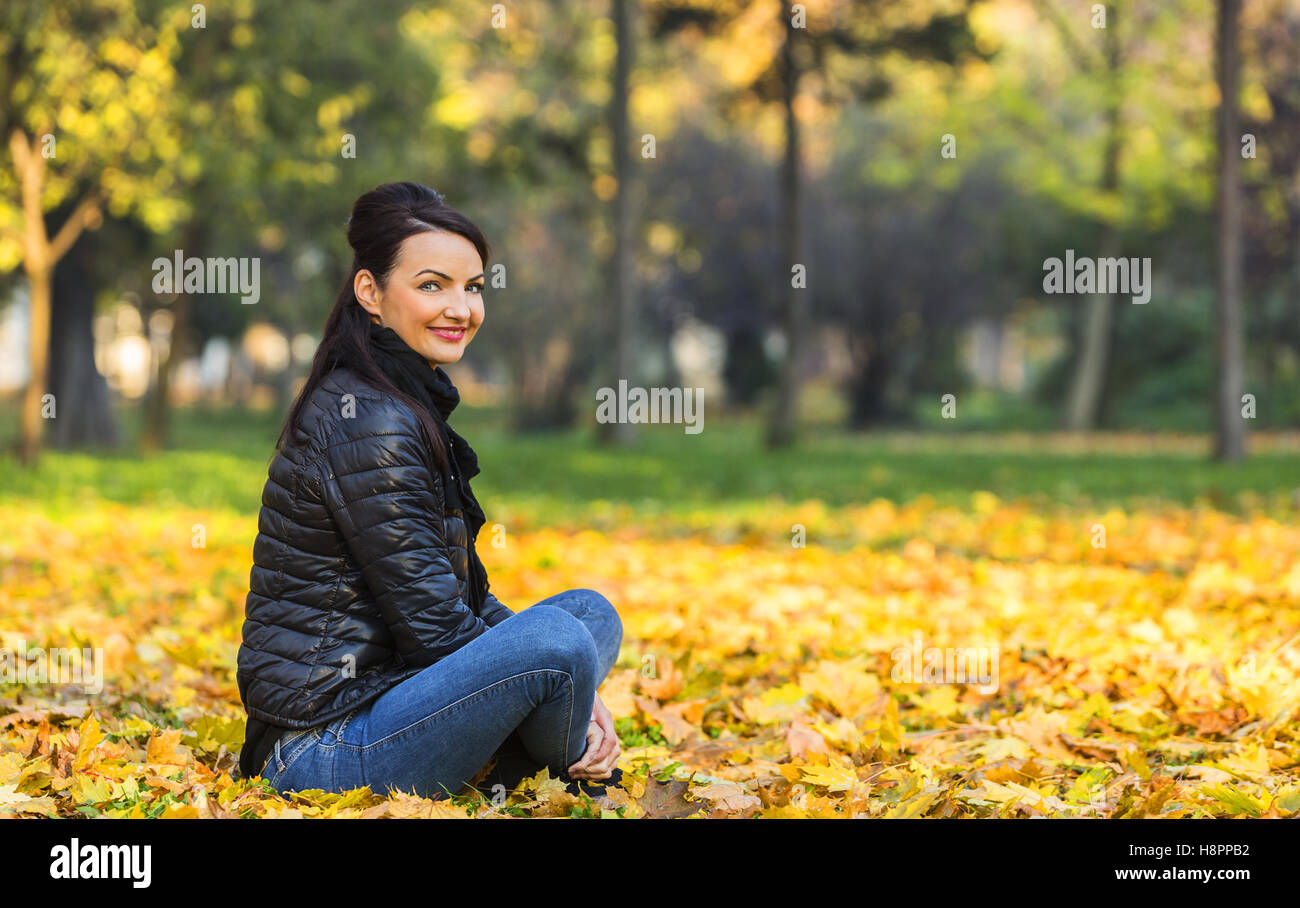 Portrait of a young smiling woman in a yellow autumn forest Stock Photo ...