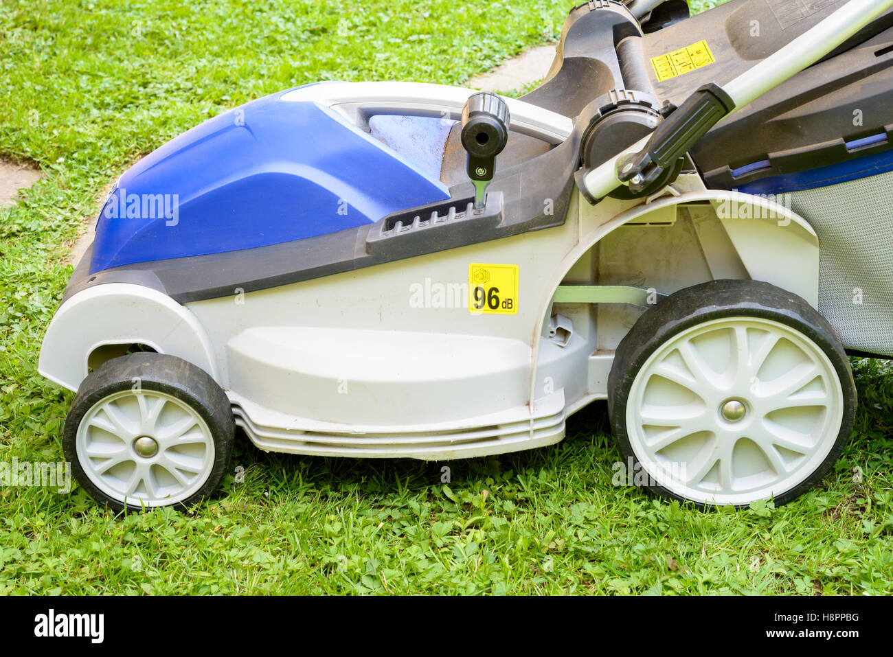 Blue Lawnmower in a garden during the work Stock Photo - Alamy