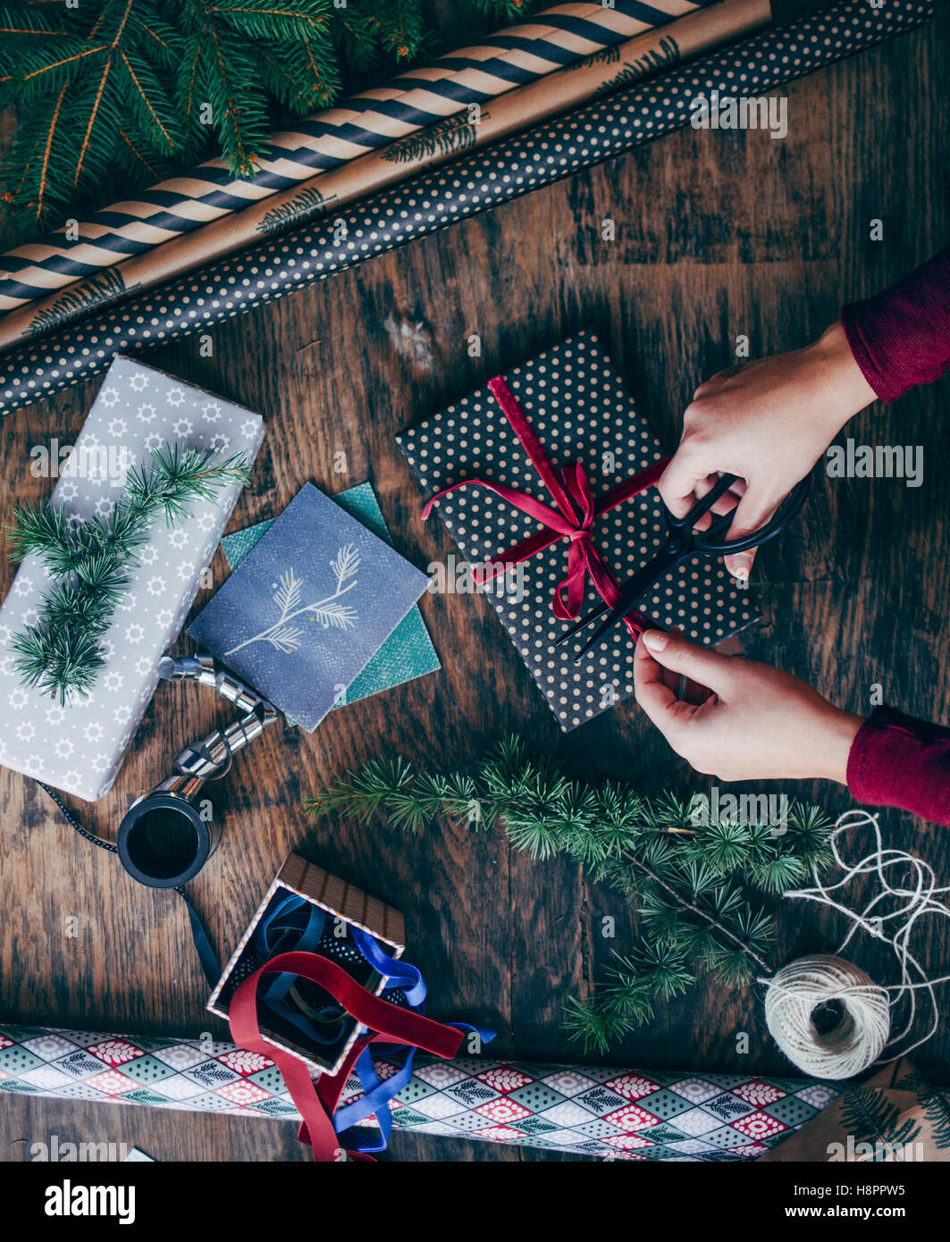 Woman Wrapping and Decorating Christmas Present Stock Photo Alamy