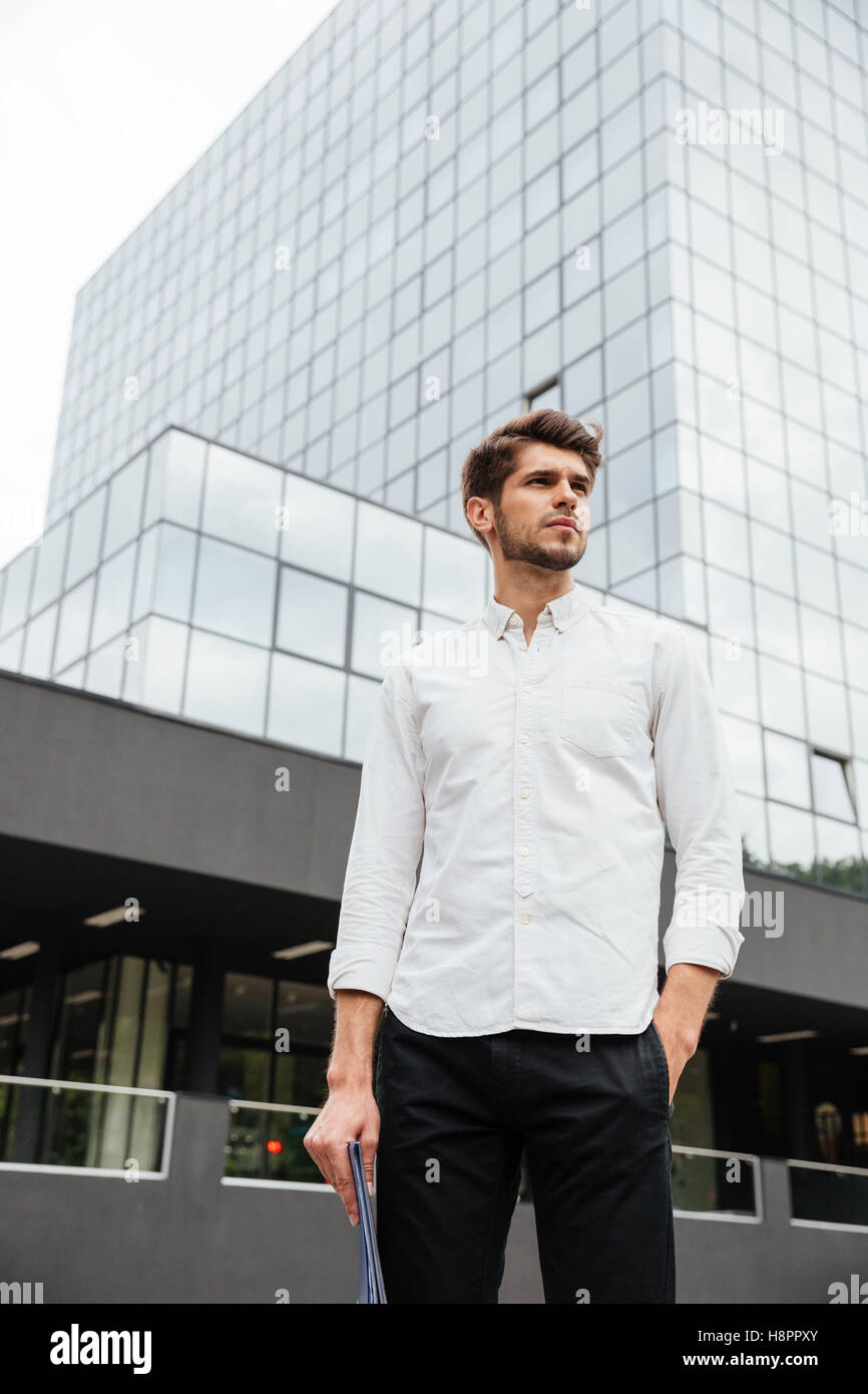 Serious young businessman standing in the city Stock Photo