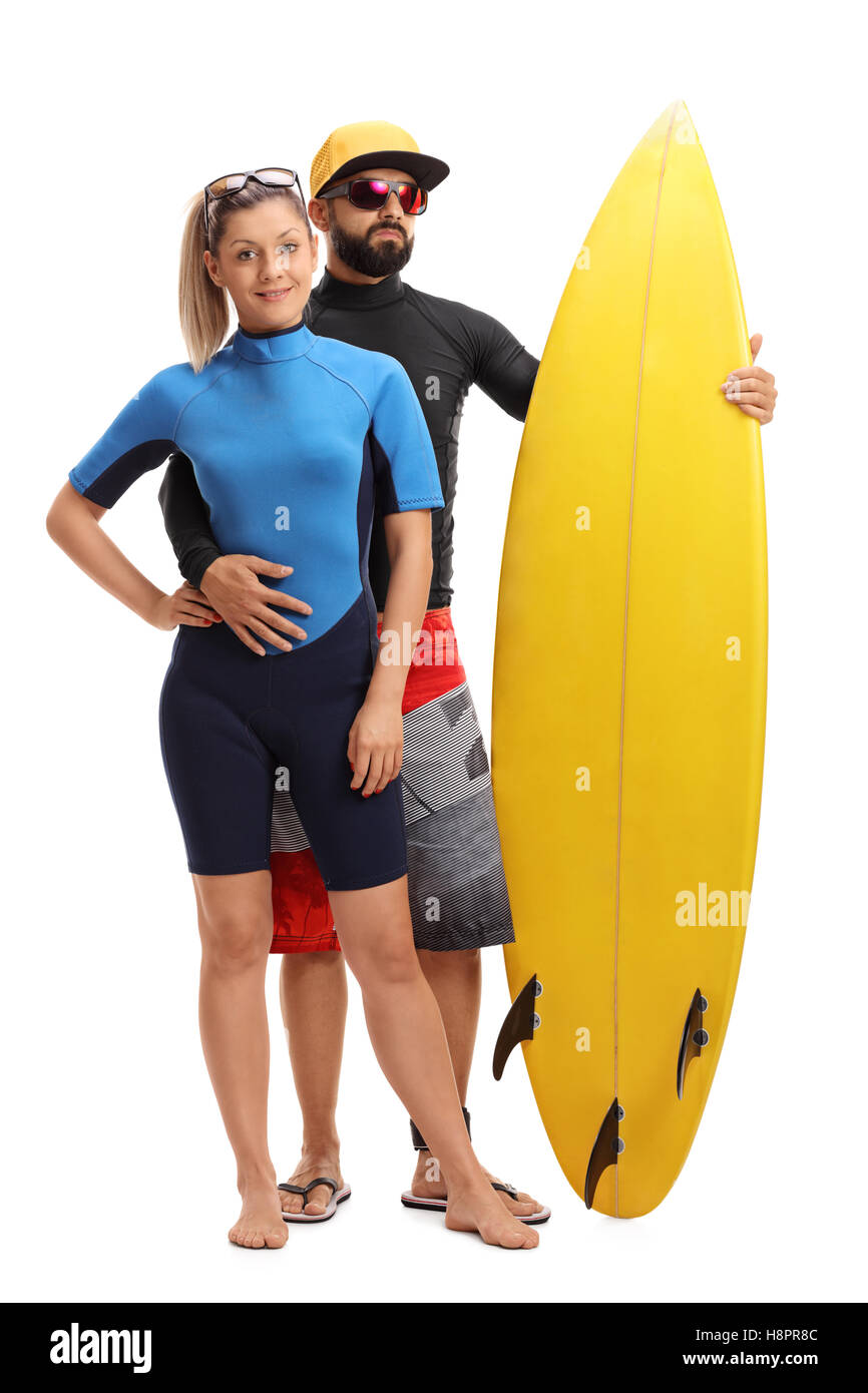 Full length portrait of young surfers posing with a surfboard isolated on white background Stock Photo
