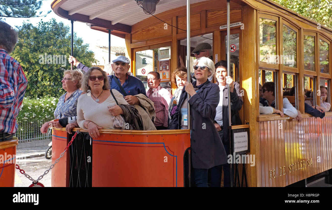 Tourists on the tram that runs from Soller to the port of Soller Stock Photo