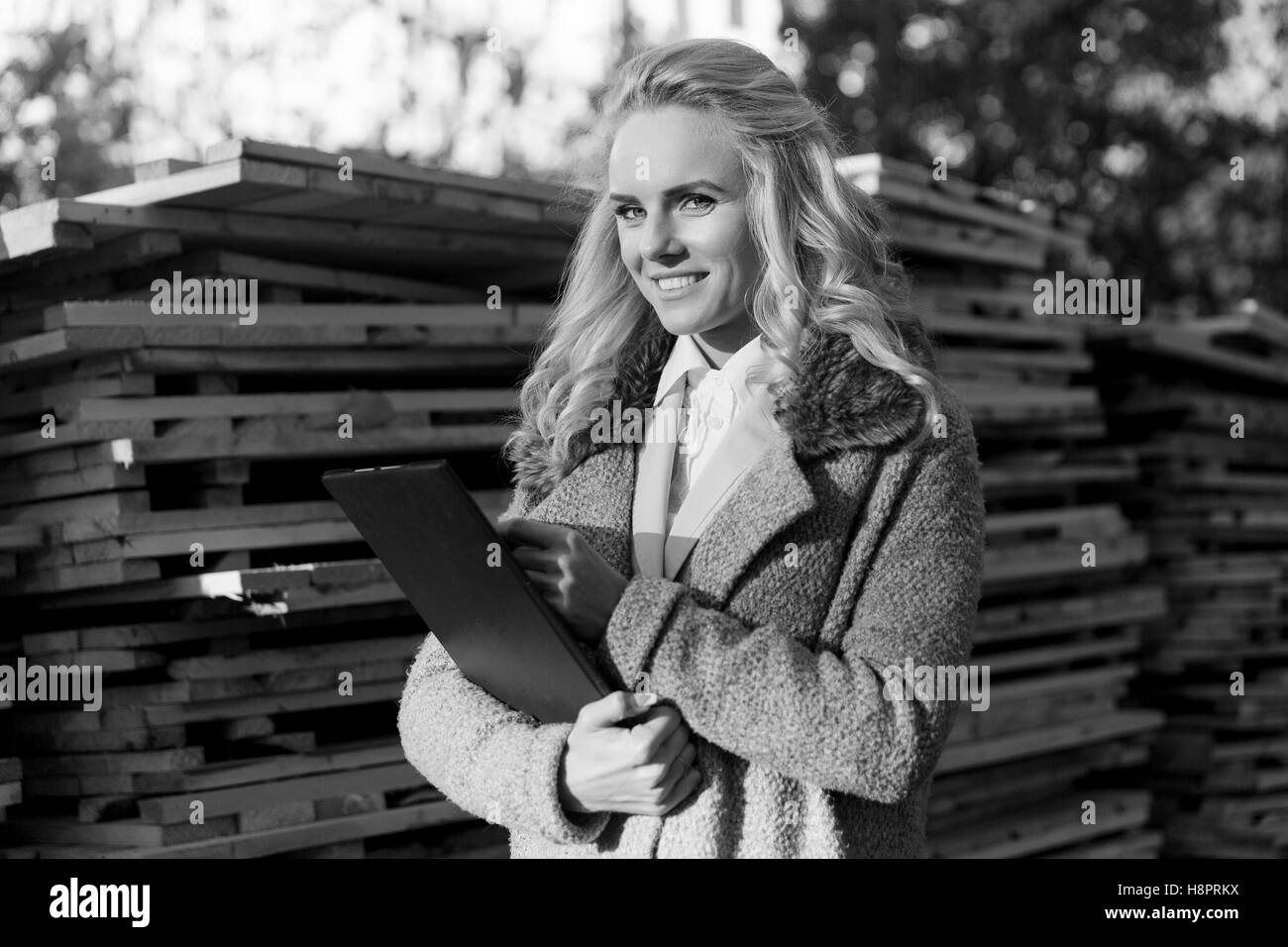 Black and white portrait of businesswoman writes test results Stock Photo