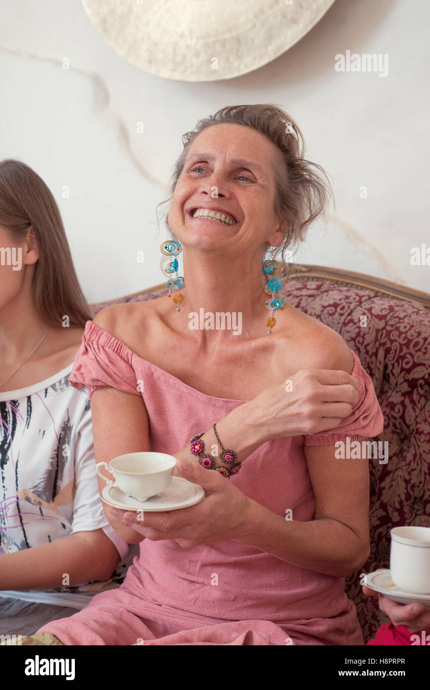 Portrait of a happy elderly woman with a cup of tea Stock Photo