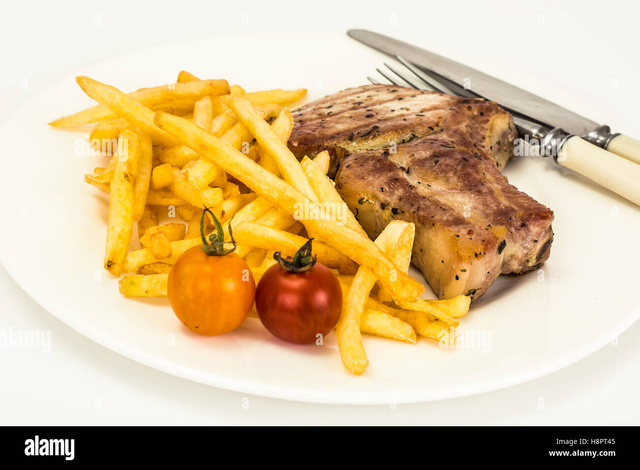 Loin Roast with Potatoes Fries on White Stock Photo Alamy