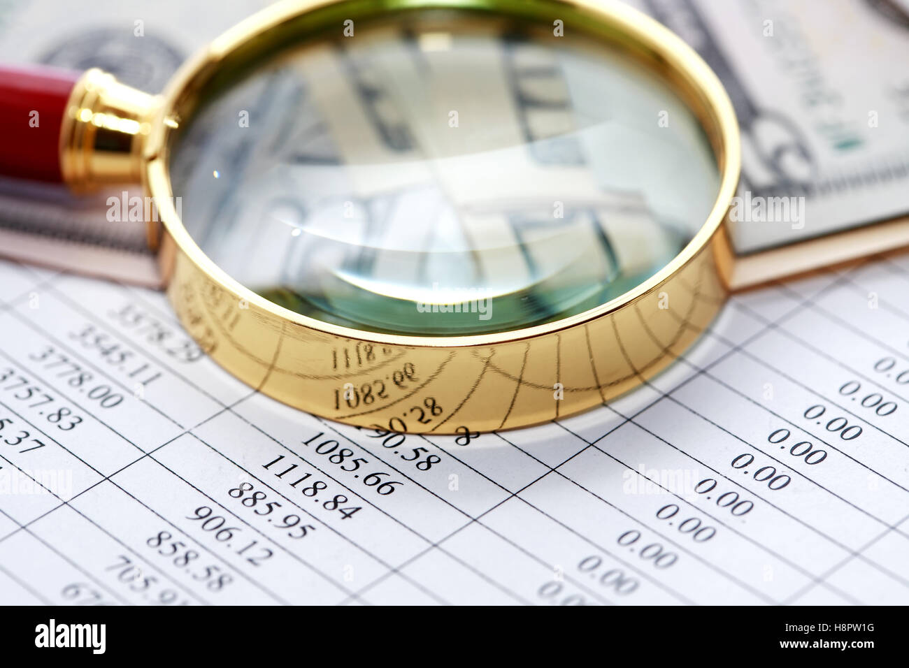 Magnifying glass near money on paper background with digits Stock Photo