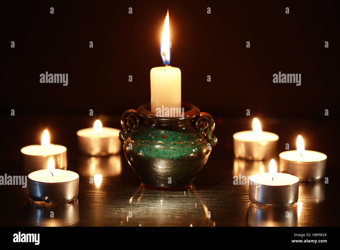 Set of lighting candles in a row against dark background Stock Photo ...
