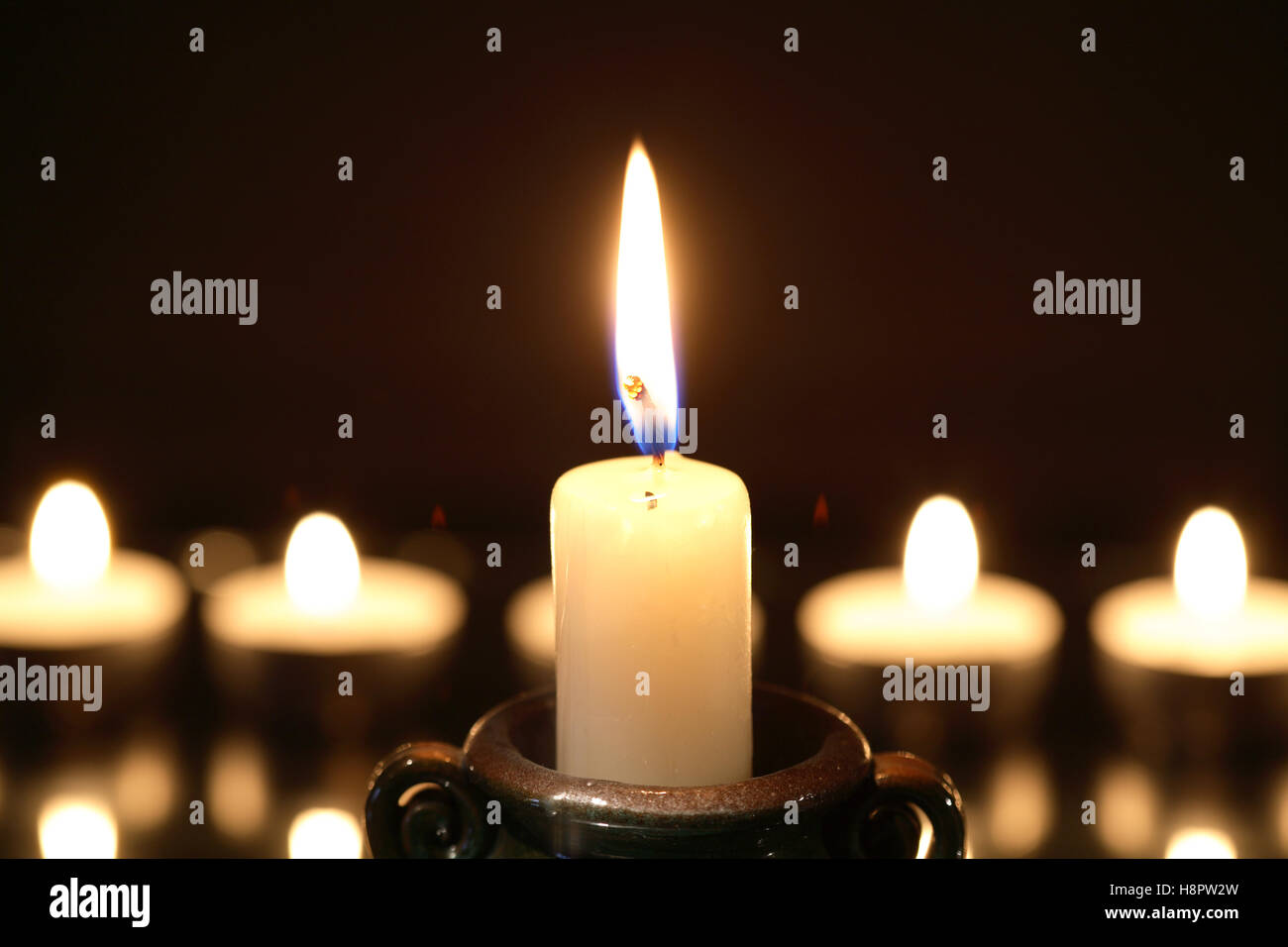 Set of lighting candles in a row against dark background Stock Photo ...