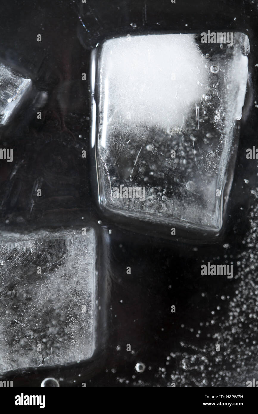 Black frozen water surface with ice cubes Stock Photo