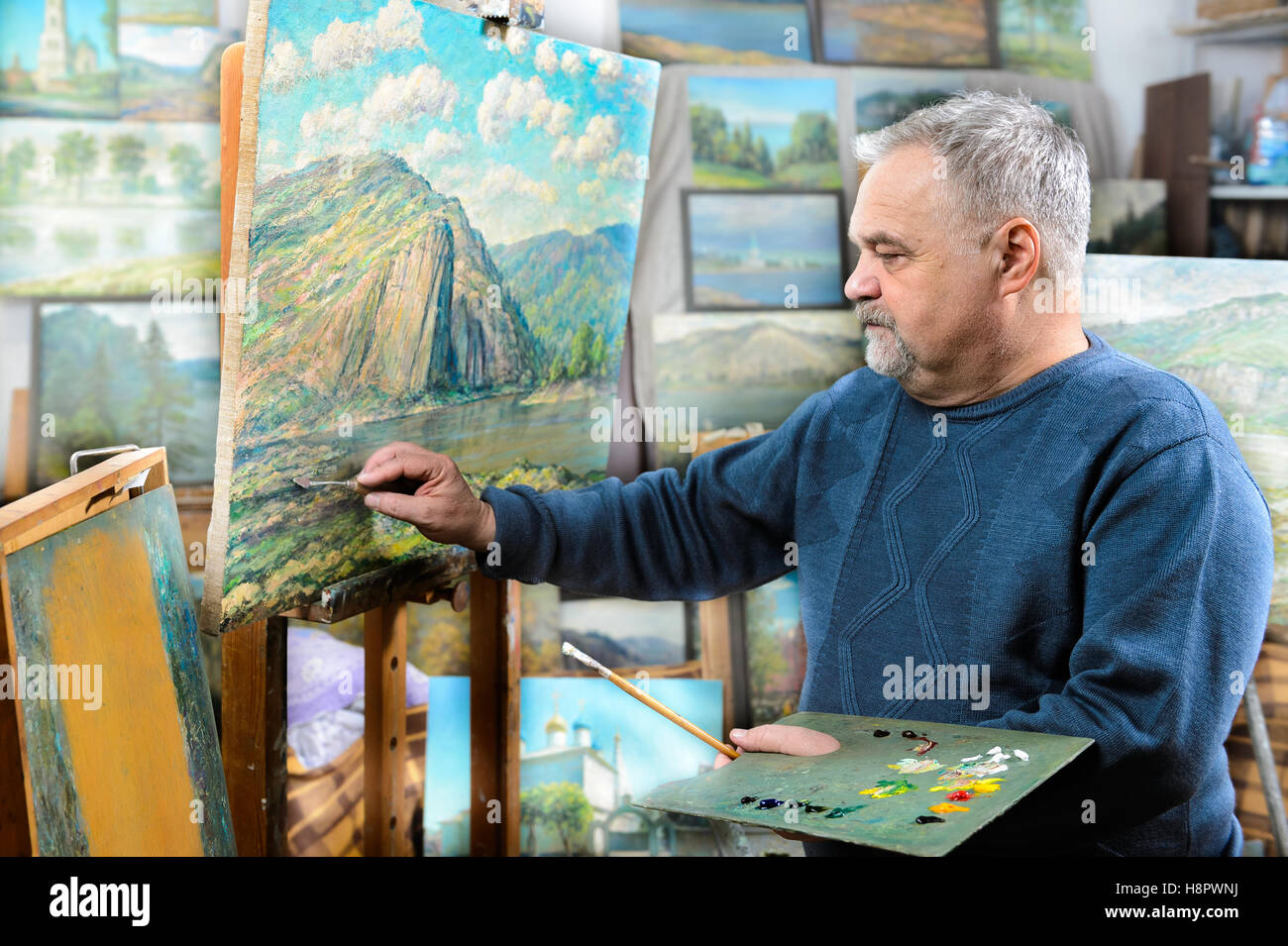 artist paints oil painting with a brush and palette Stock Photo - Alamy