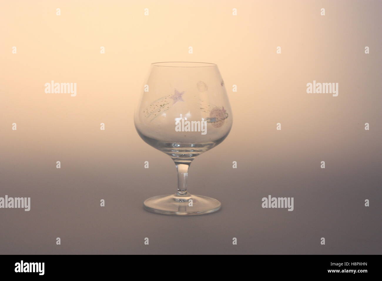 Brandy glass with a space pattern painted on Stock Photo