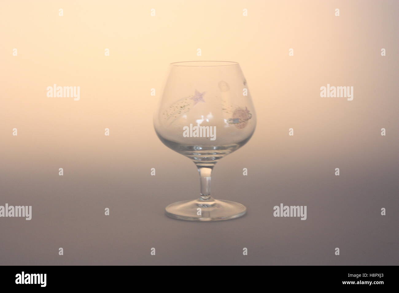 Brandy glass with a space pattern painted on Stock Photo