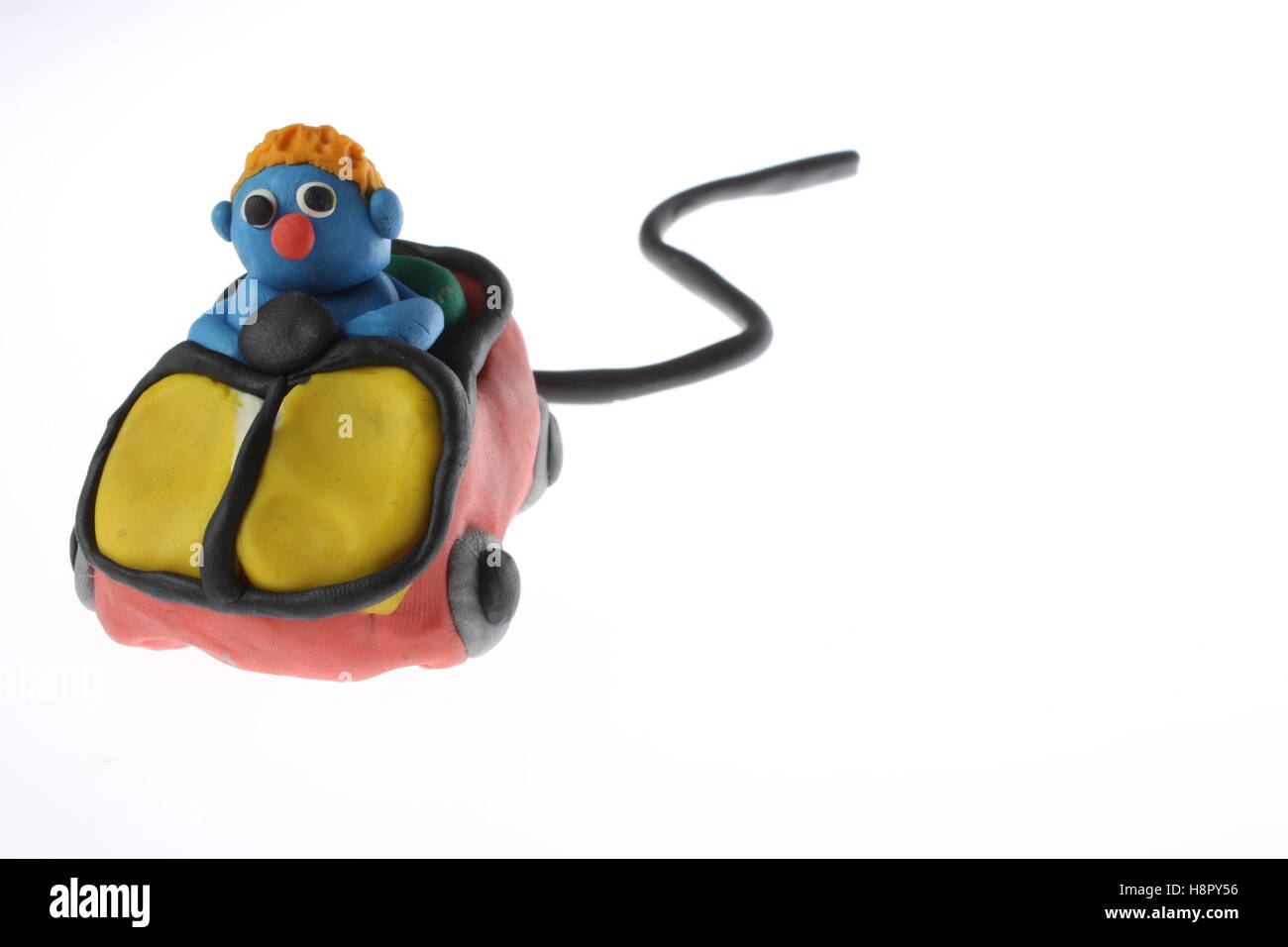 Play doh model of a man driving a computer mouse ideal logo imagery for car insurance / cover comparison company Stock Photo