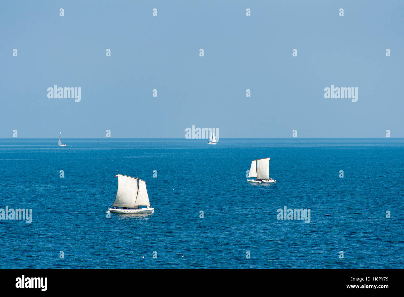 Sailboats sailing on deep blue sea and sky Stock Photo - Alamy