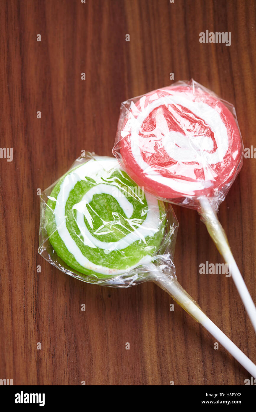 candy on a stick on a wood background Stock Photo Alamy