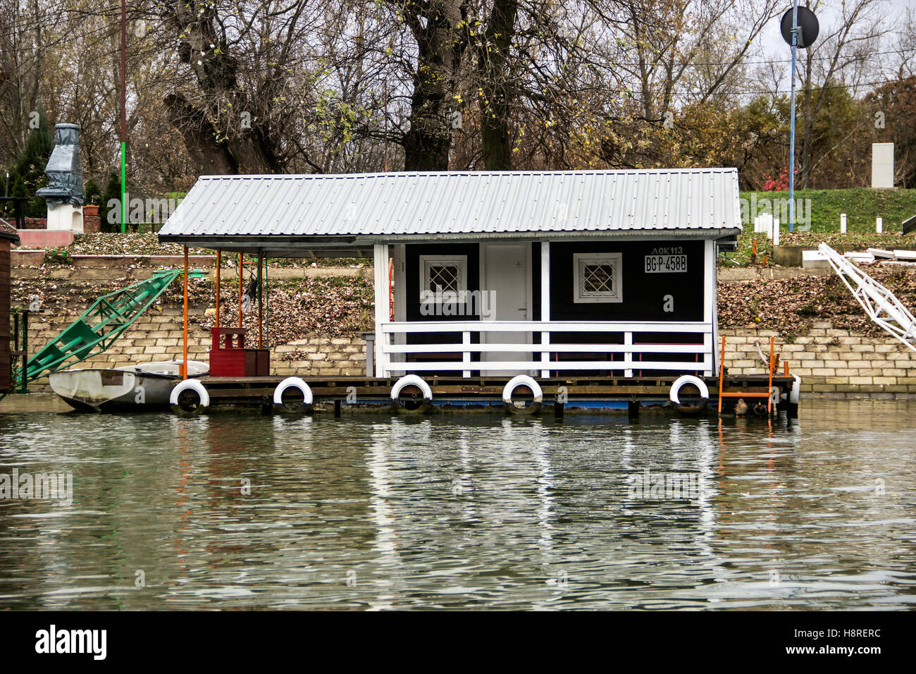Sava river, Serbia - A raft house moored to the shoreline of Ada Medjica islet Stock Photo