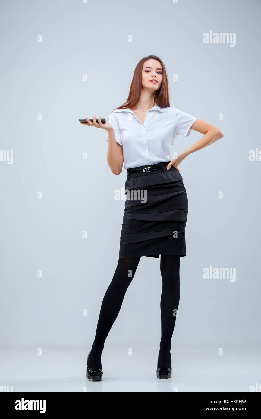 The young business woman on gray background Stock Photo - Alamy