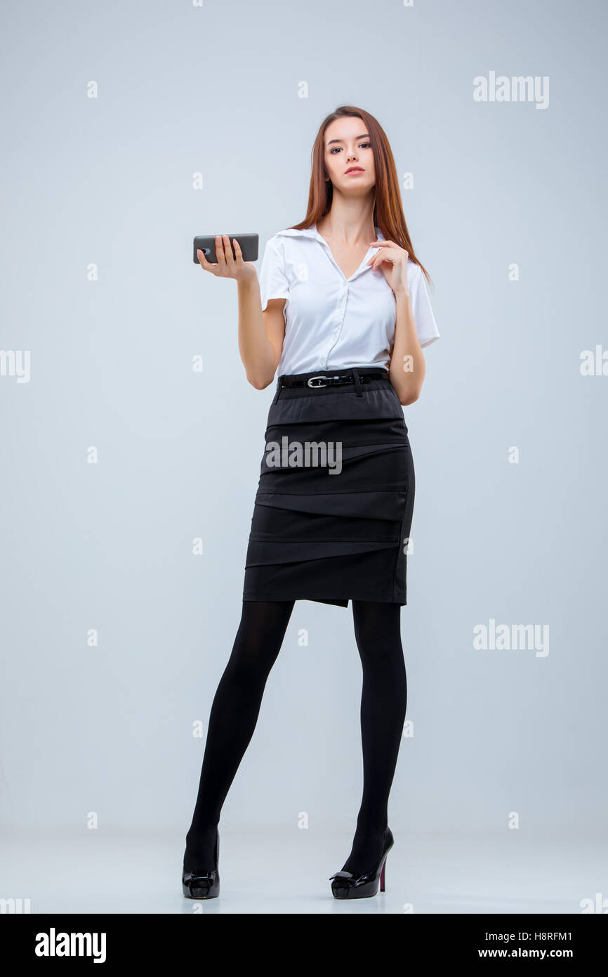 The young business woman on gray background Stock Photo - Alamy