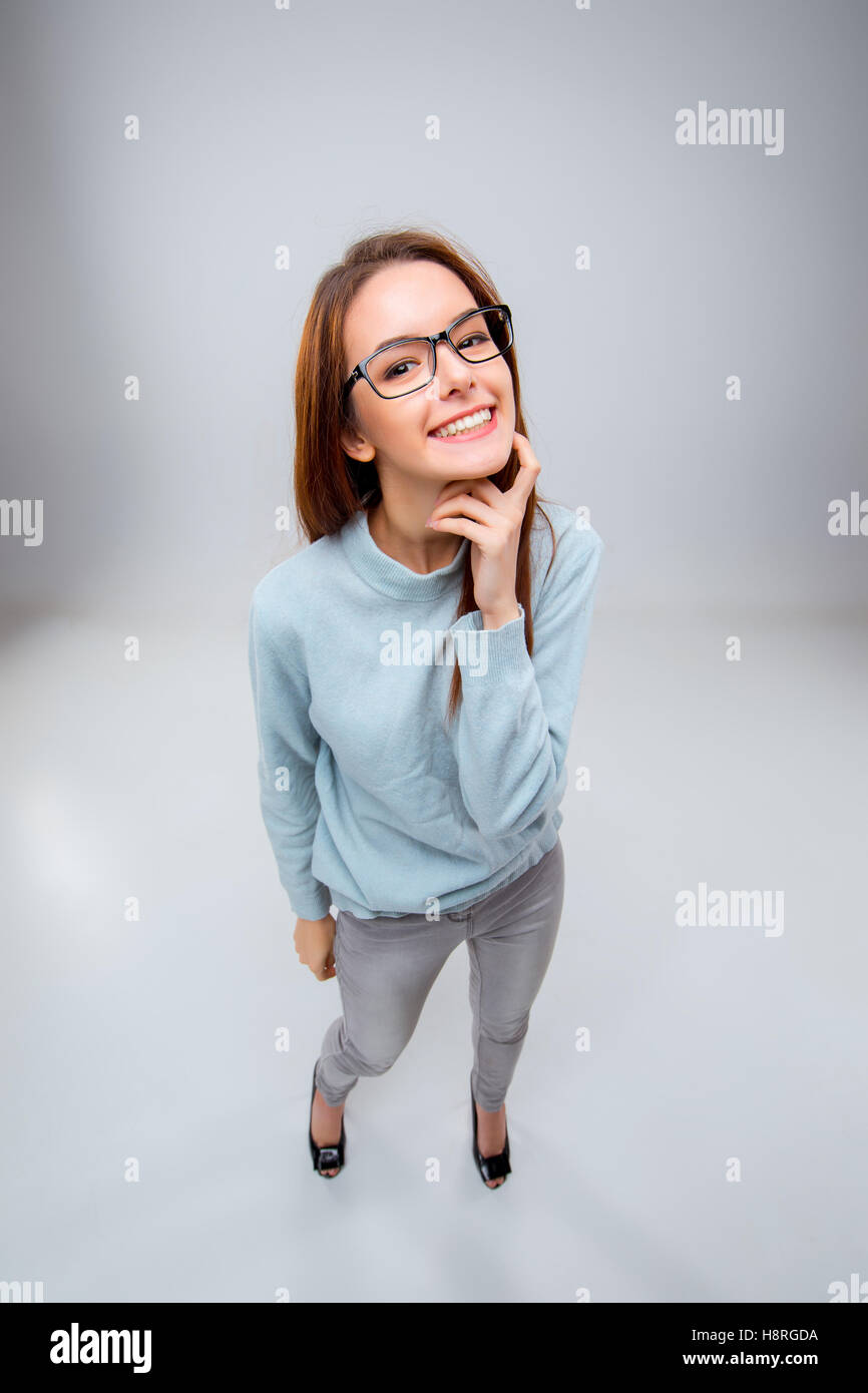 The smiling young business woman on gray background Stock Photo - Alamy