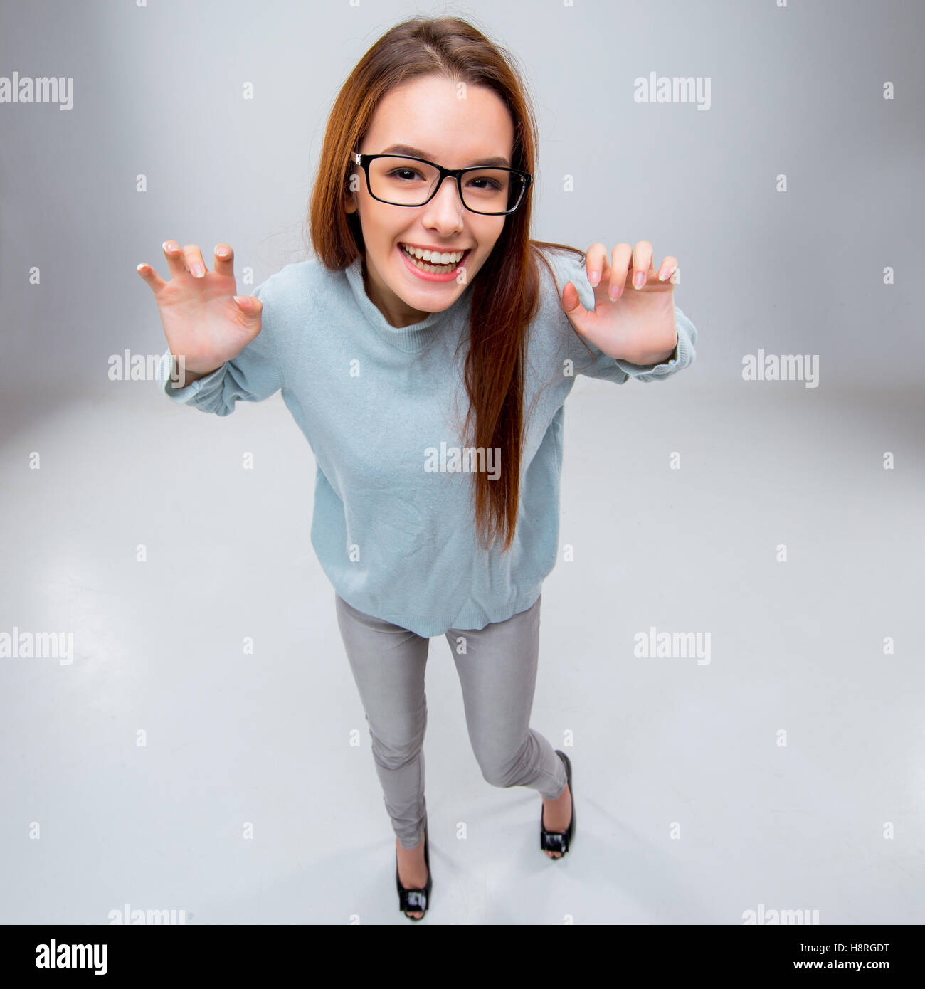 The smiling young business woman on gray background Stock Photo - Alamy