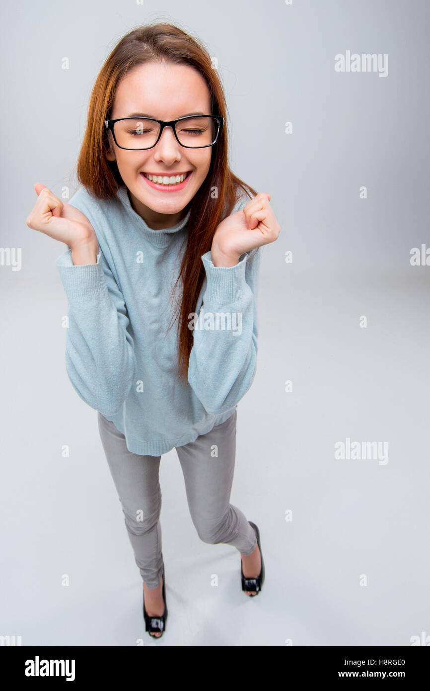 The smiling young business woman on gray background Stock Photo - Alamy