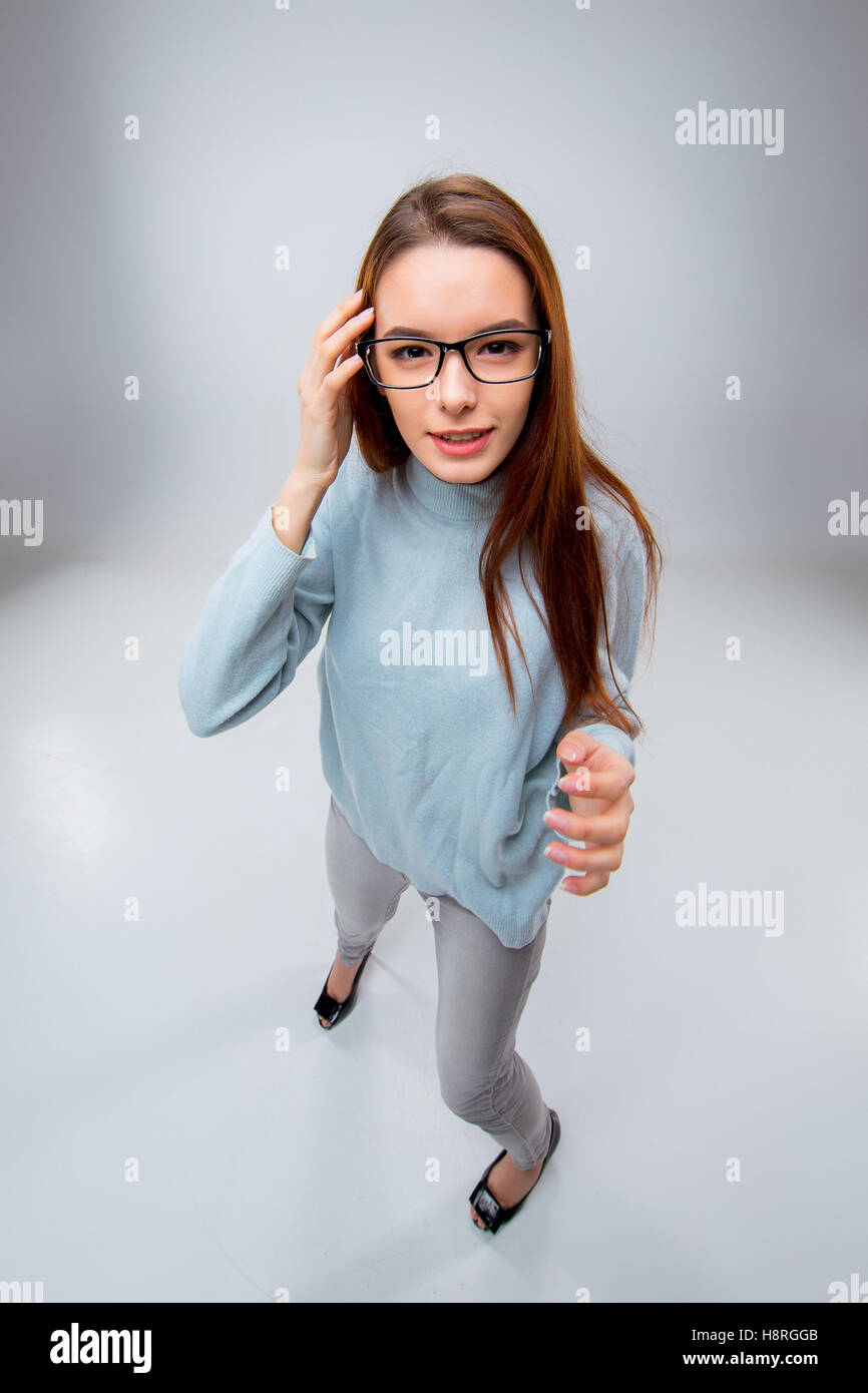 The smiling young business woman on gray background Stock Photo - Alamy
