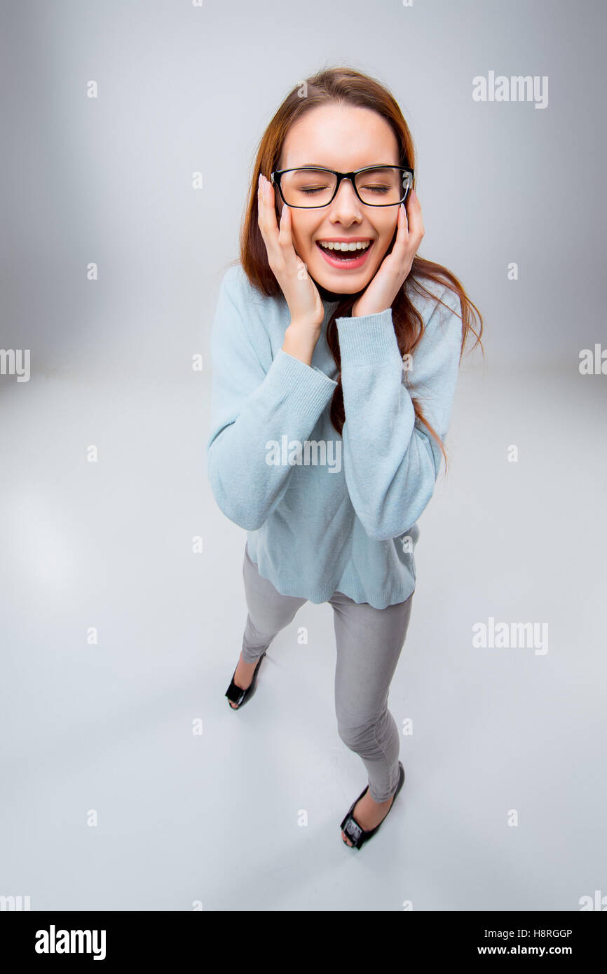 The smiling young business woman on gray background Stock Photo - Alamy