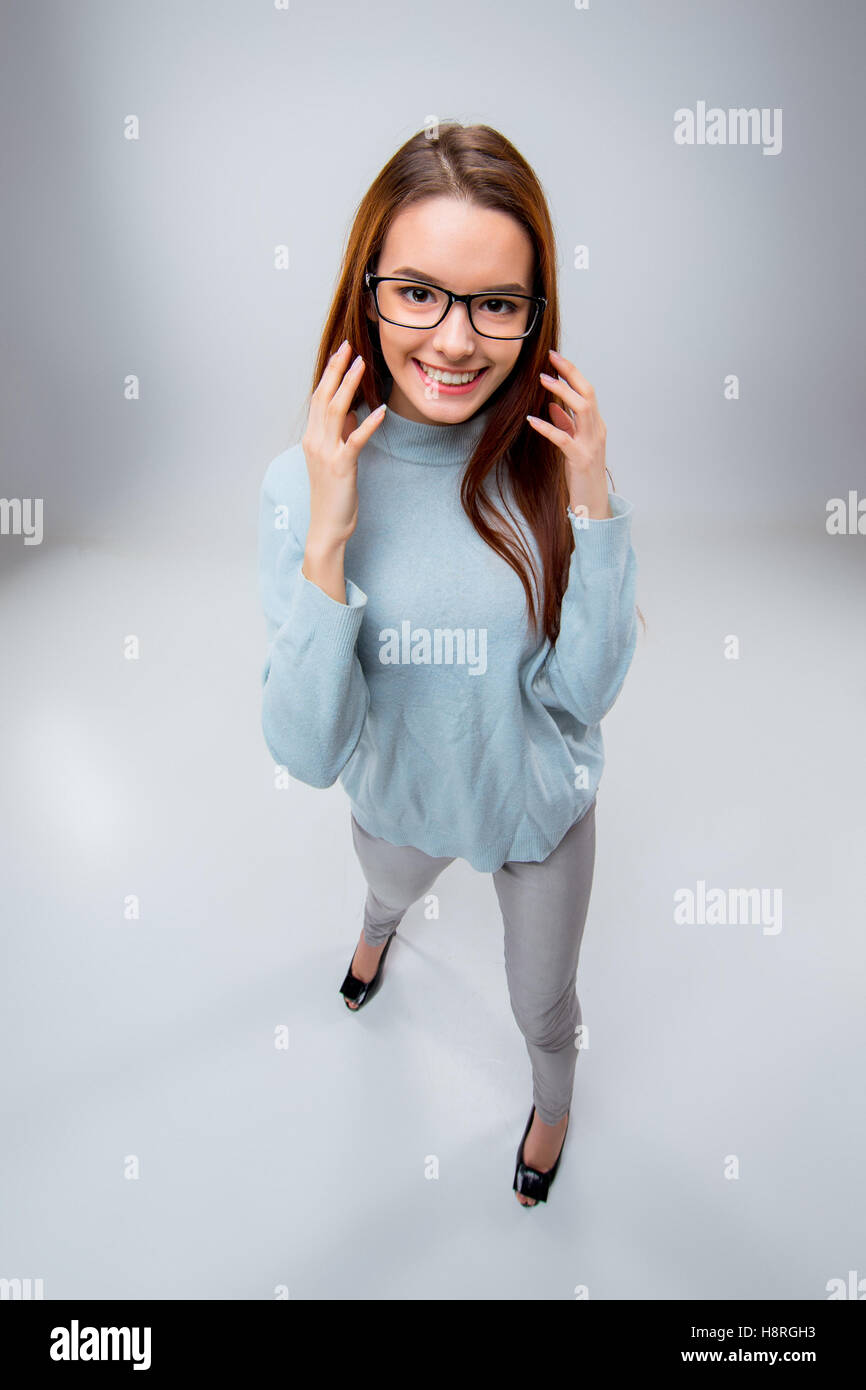 The smiling young business woman on gray background Stock Photo - Alamy