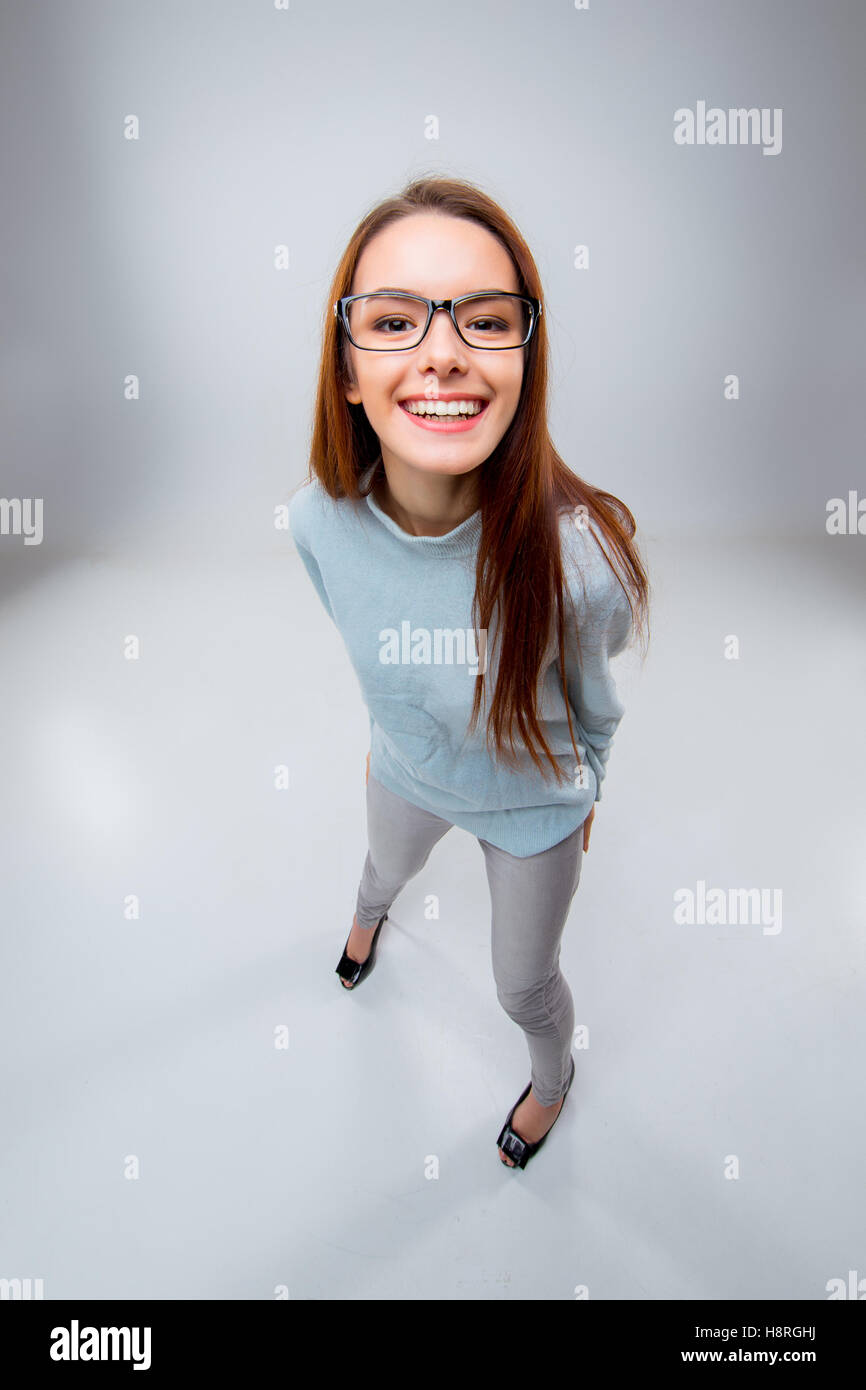 The smiling young business woman on gray background Stock Photo - Alamy
