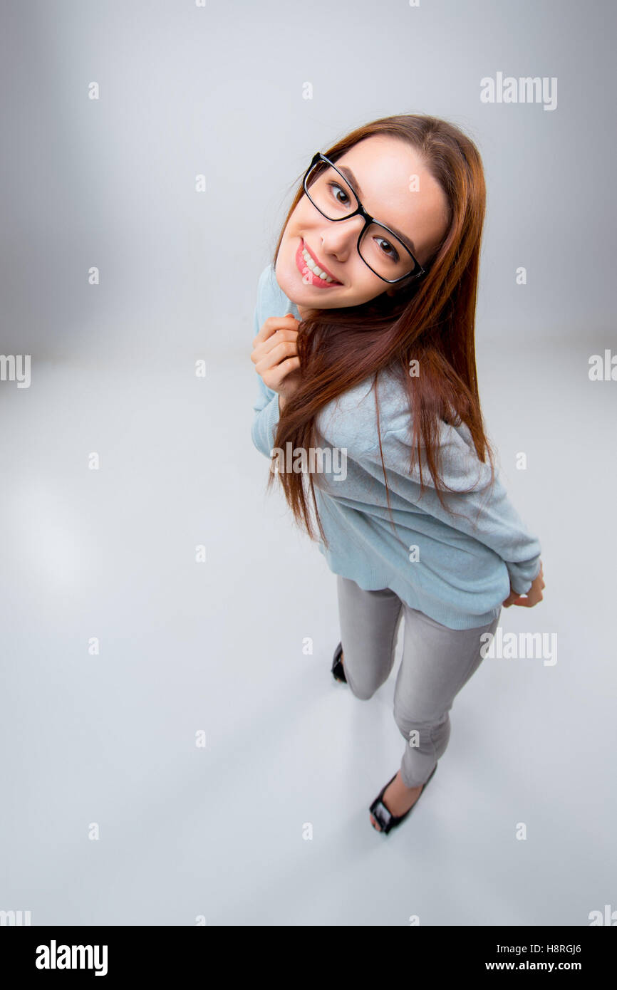 The smiling young business woman on gray background Stock Photo - Alamy