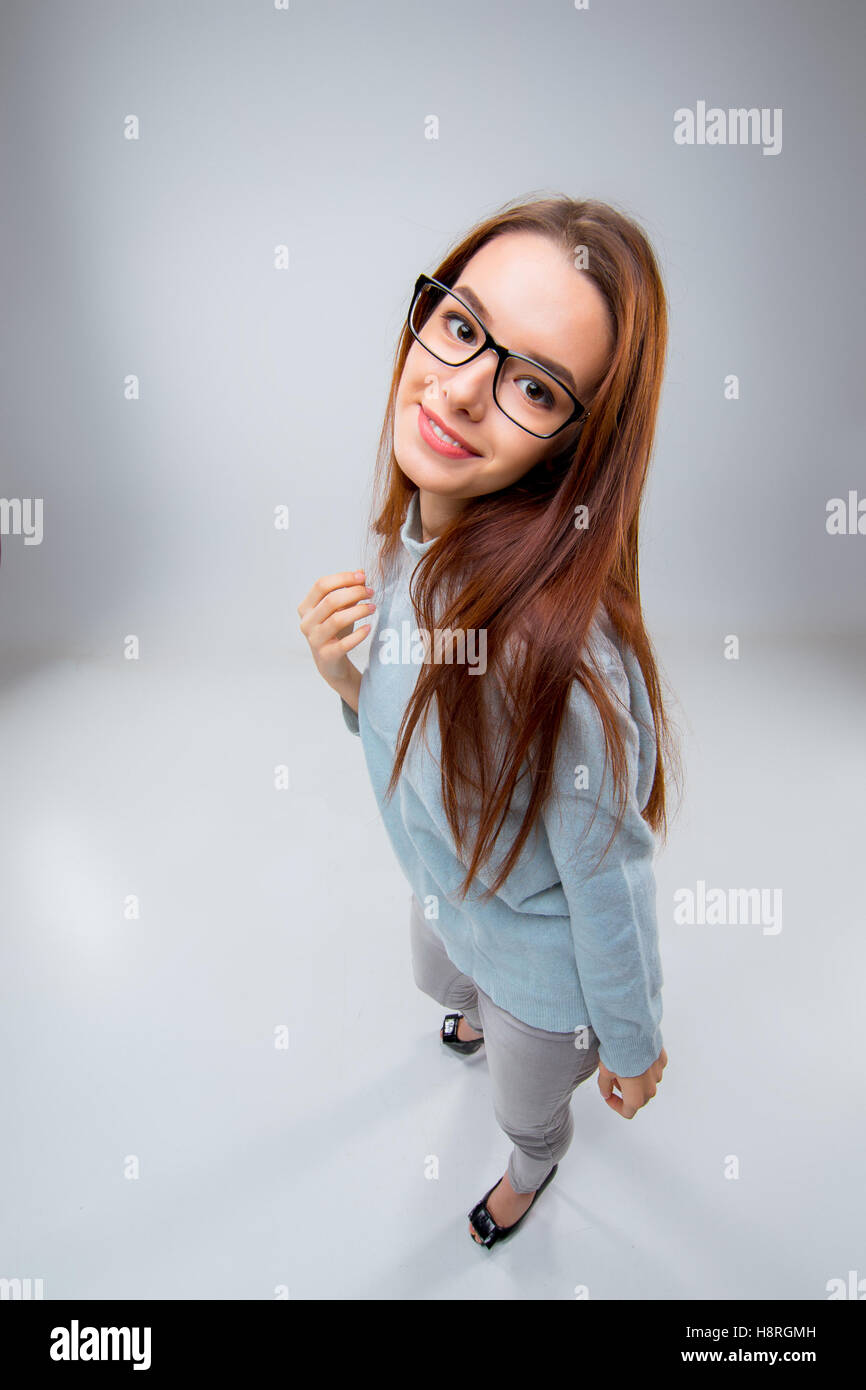 The smiling young business woman on gray background Stock Photo - Alamy