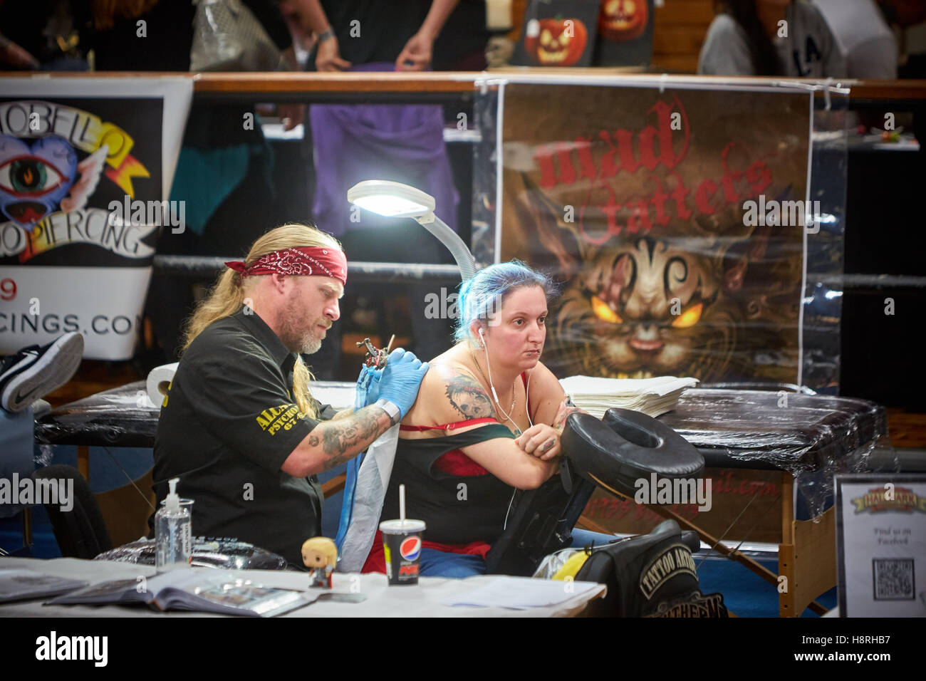 A woman getting a tattoo at Oxford's first tattoo convention Stock ...
