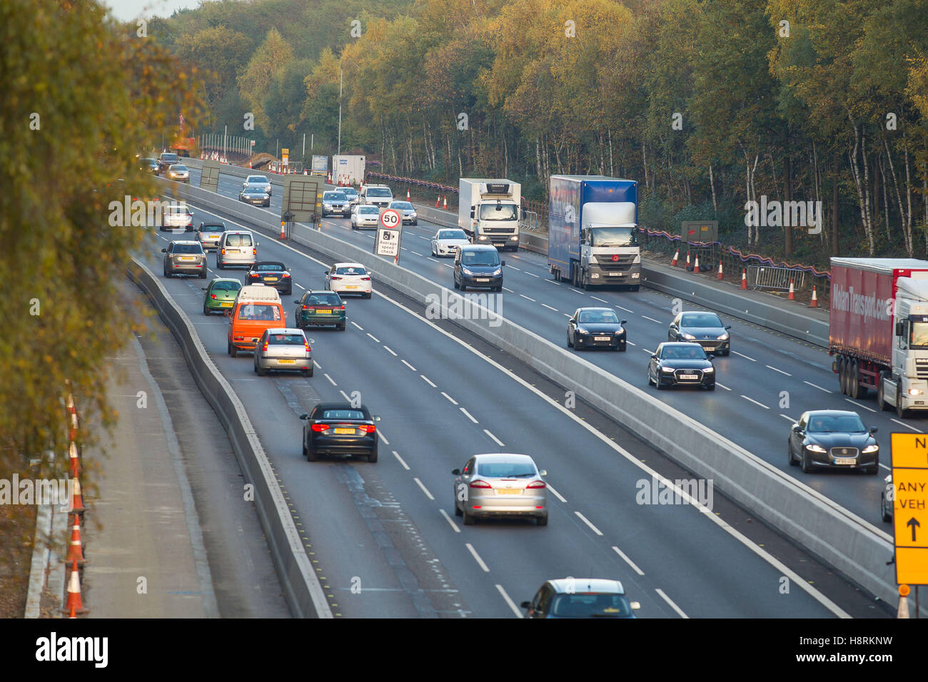Cars, vans and trucks travel through a 50mph zone in roadworks on the M3 in Surrey, England, Britain. Stock Photo