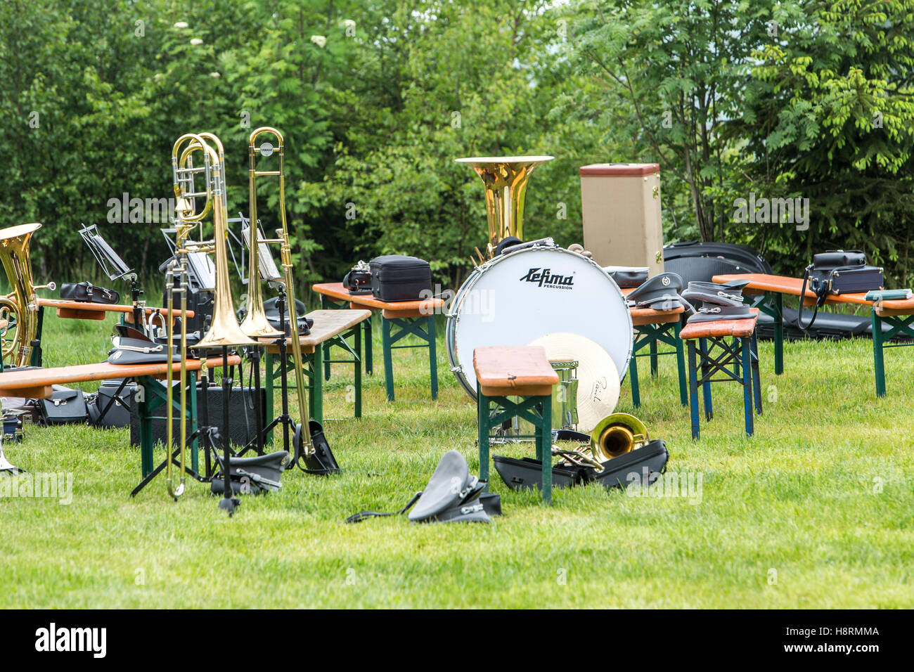Musical instruments of a music corps, at a festive event, various wind instruments, notes, timpani, on benches, band on a break Stock Photo