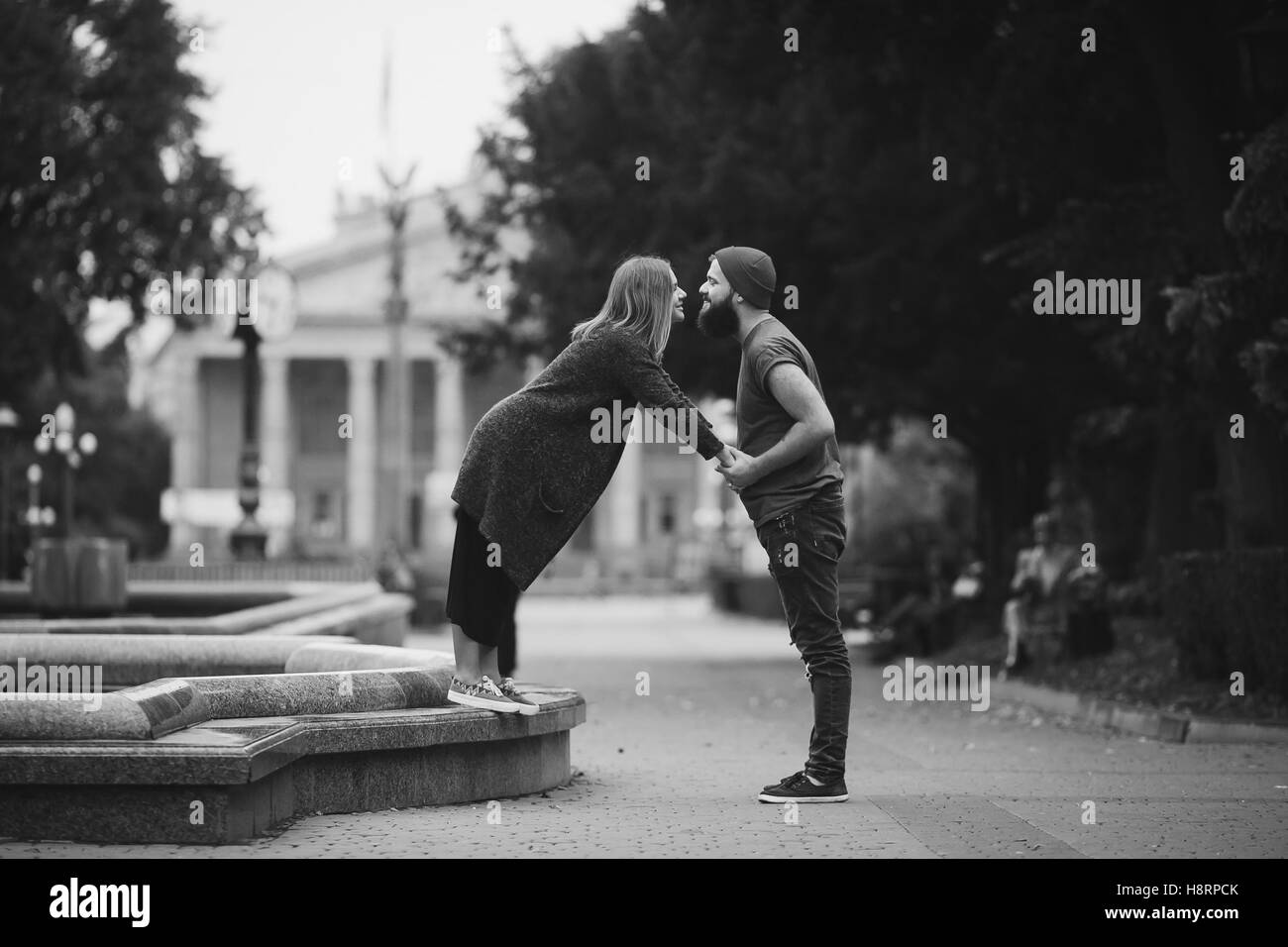 man and woman are kissing on the street Stock Photo - Alamy