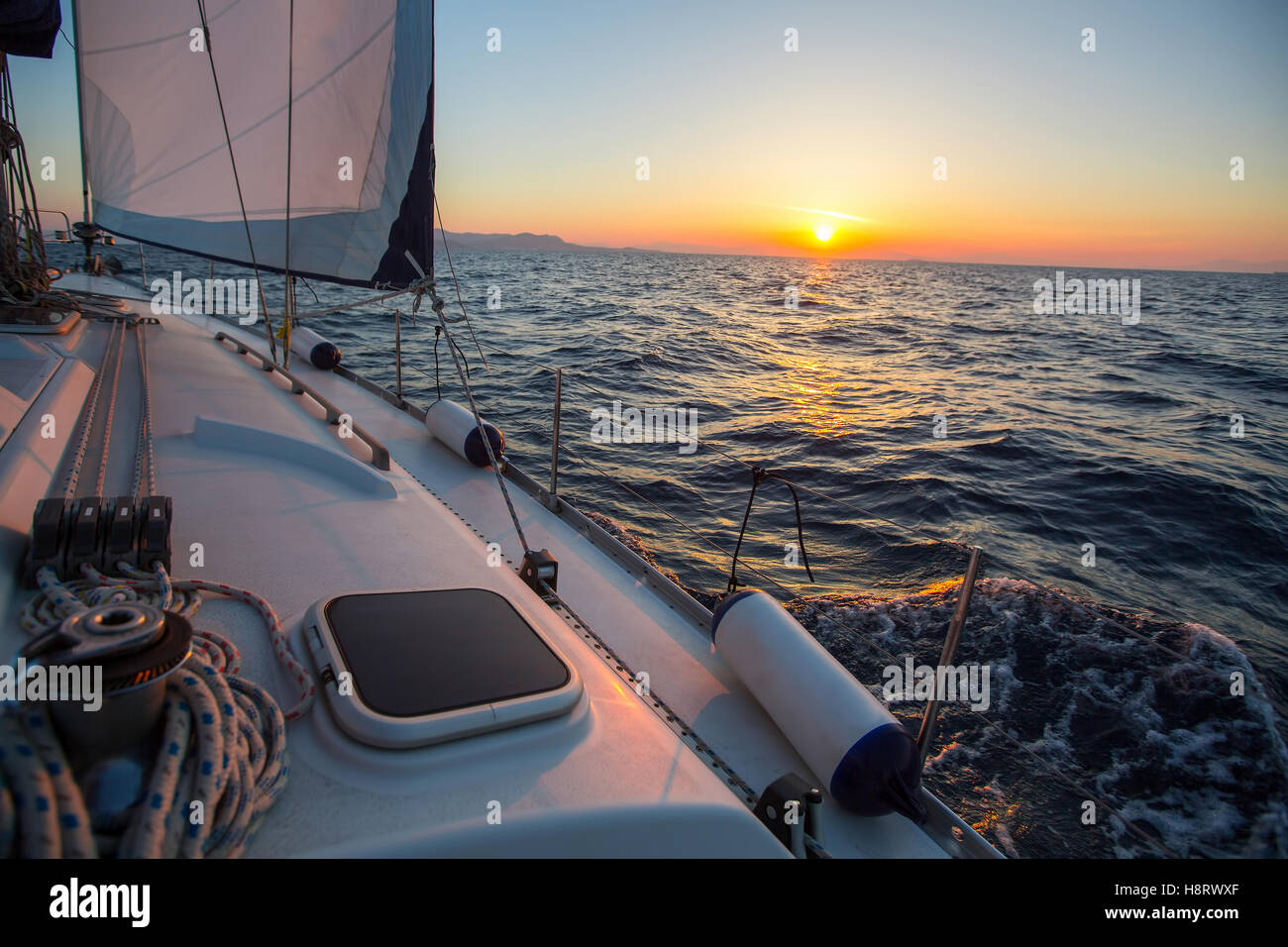 Amazing sunset on a sailing yacht ship boat at the Sea Stock Photo - Alamy