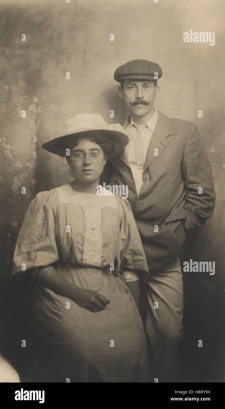 Couple in photo studio in Folkestone August 1908. Man sporting large moustache. Woman in typical Edwardian fashions and hat of the day. Stock Photo