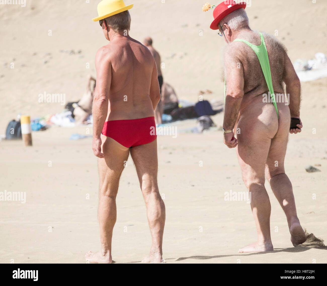 Elderly man wearing a mankini on beach Stock Photo