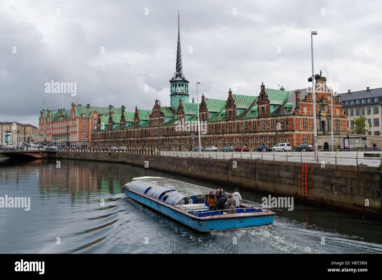 Tourist boat on Frederiksholm Canal with Copenhagen Old Stock Exchange, Borsen, Copenhagen, Denmark Stock Photo