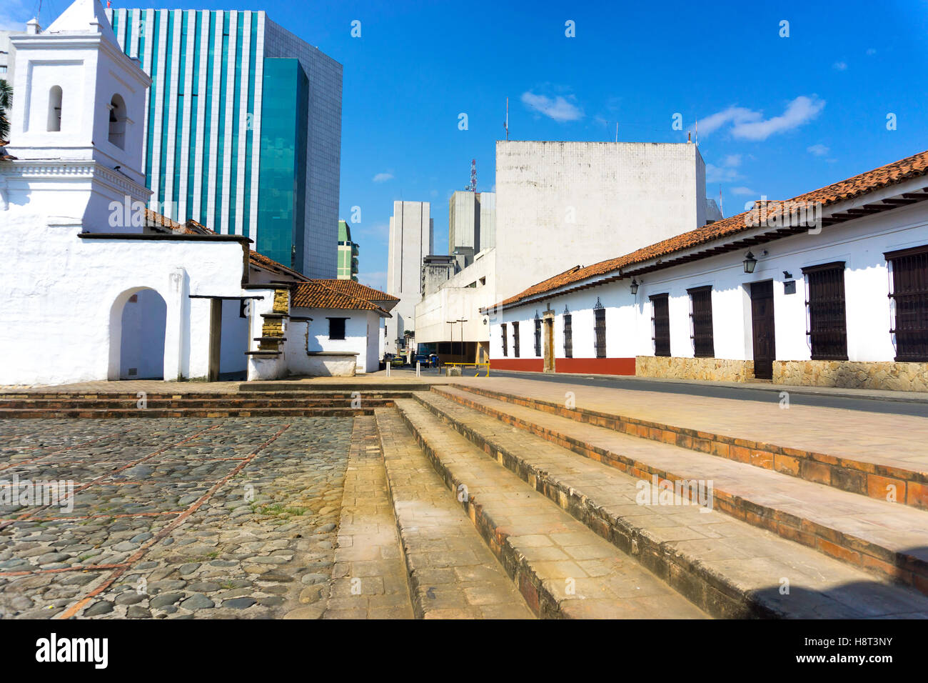 View of the historic La Merced church in Cali, Colombia with modern buildings in the background Stock Photo