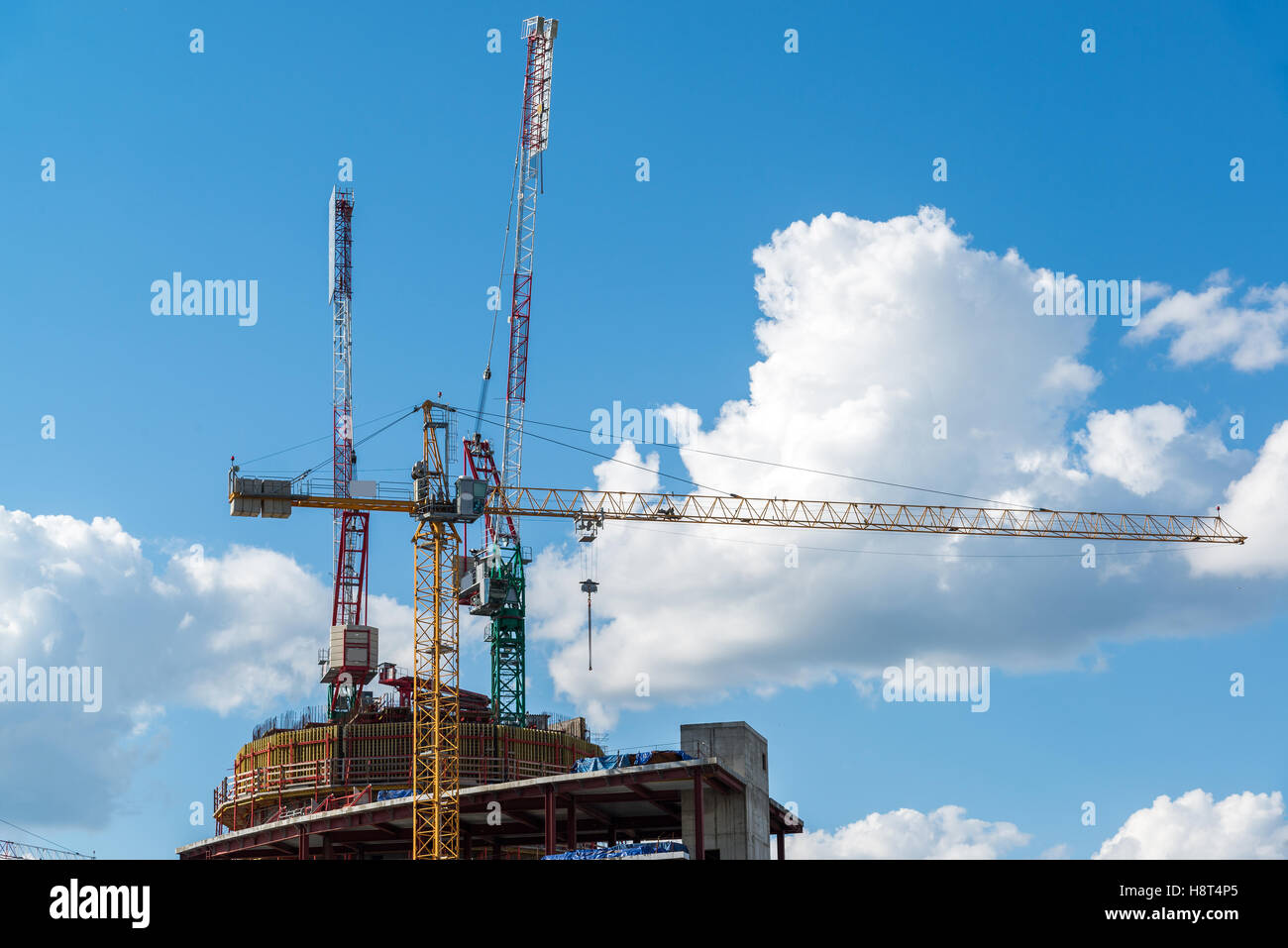 Construction cranes on background of sky with clouds Stock Photo - Alamy