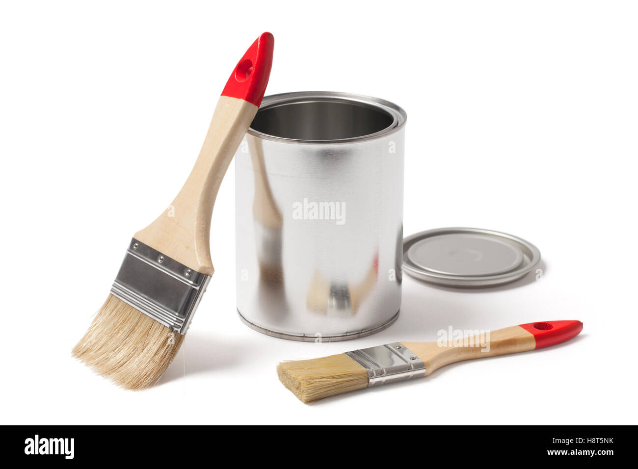 Metallic can for paint with an open lid and two new paint brushes isolated on white background with clipping path. Stock Photo