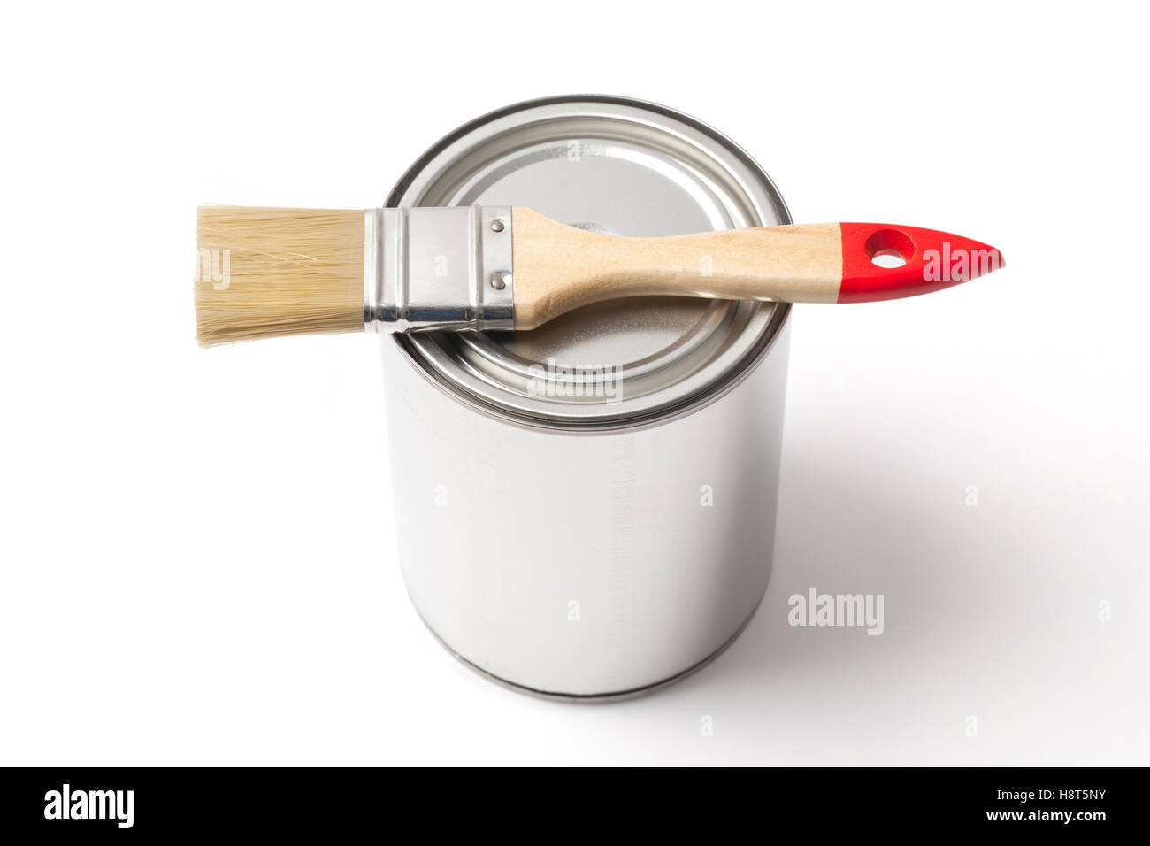 Closed blank tin paint can and new paintbrush isolated on white background with clipping path. Stock Photo