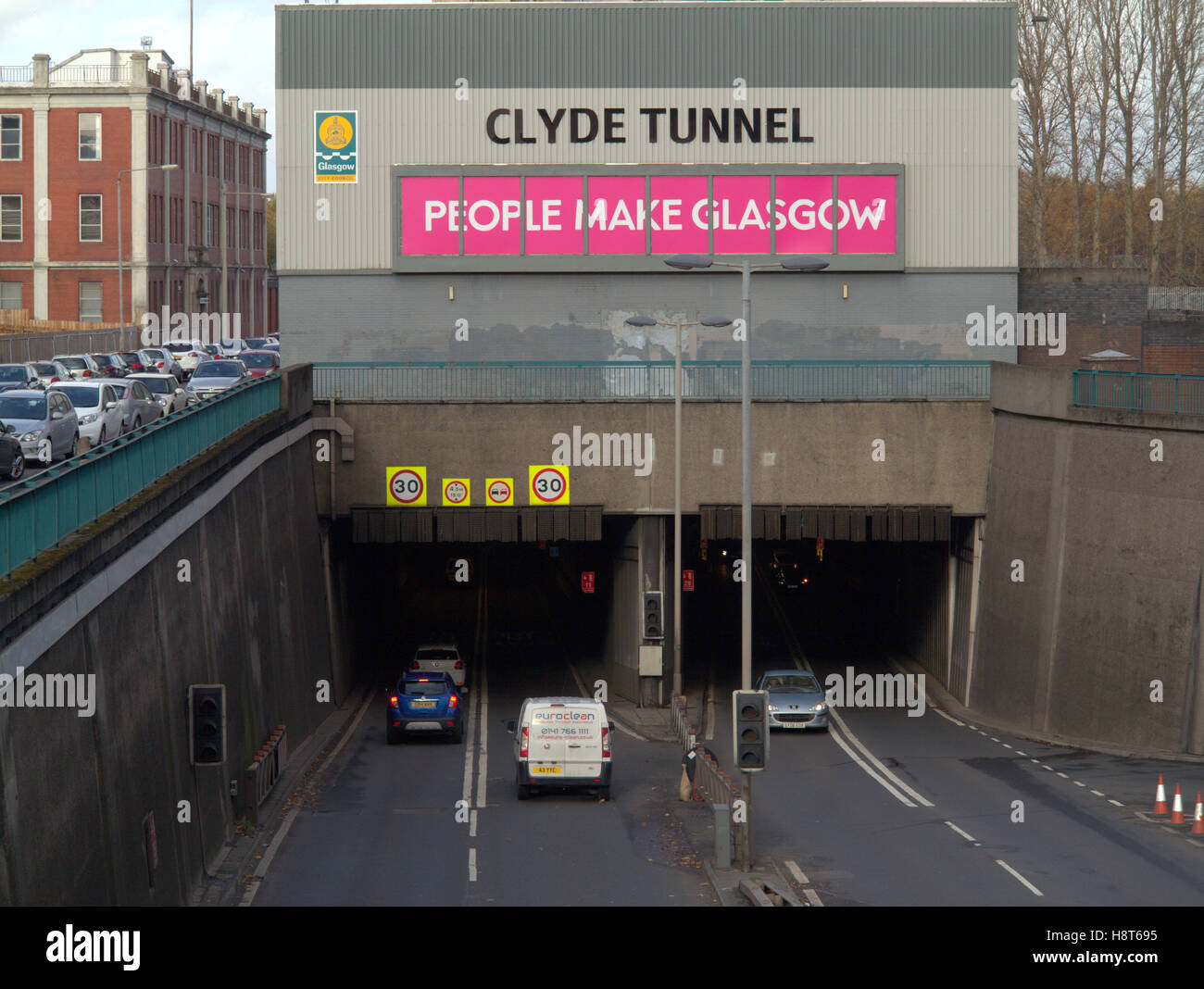 Clyde tunnel south entrance southern exit people make glasgow sign cars traffic Stock Photo