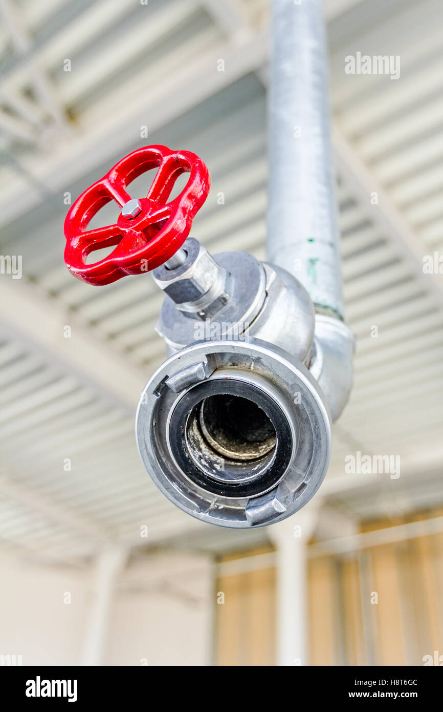Red Faucet From Firefighter Galvanized Steel Pipeline Is