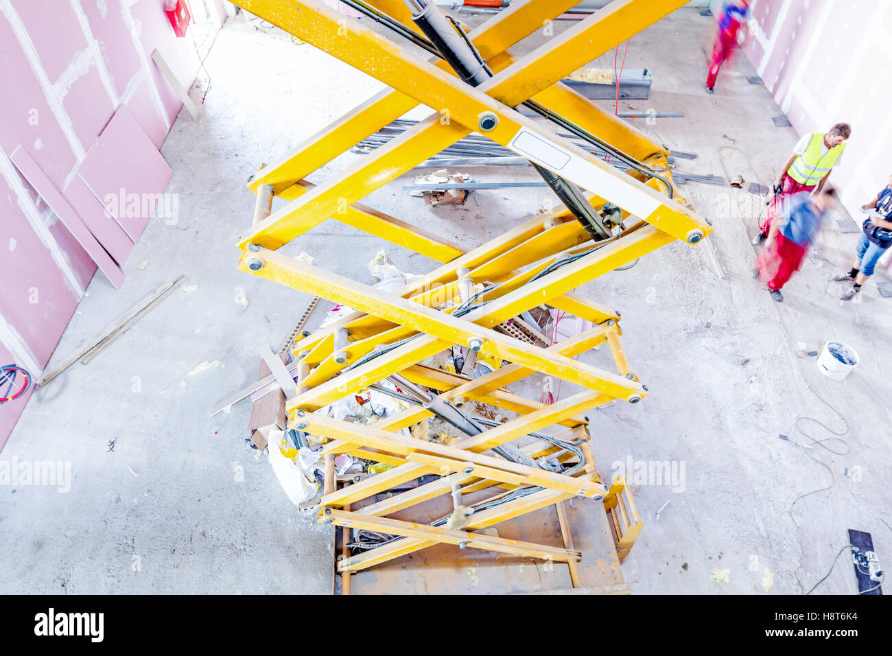 Scissor lift platform with stretched hydraulic system at maximum height range. Stock Photo