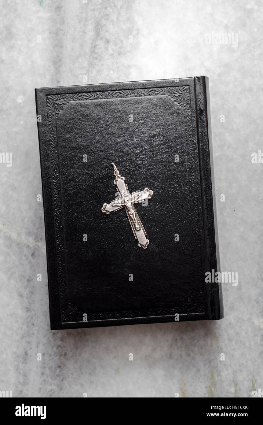 Closeup of  Christian cross on bible on the marble, from above Stock Photo
