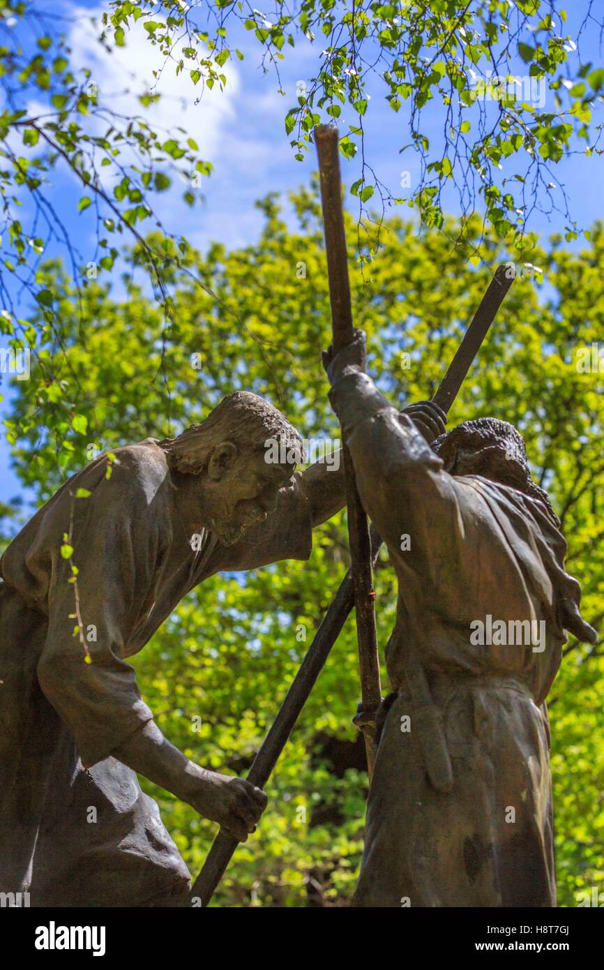 A sculpture of medieval fighting men using poles Stock Photo