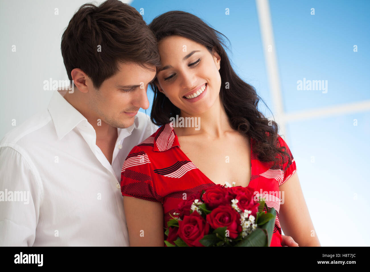 Woman holding flowers she got from her boyfriend on Valentine's Day. Stock Photo