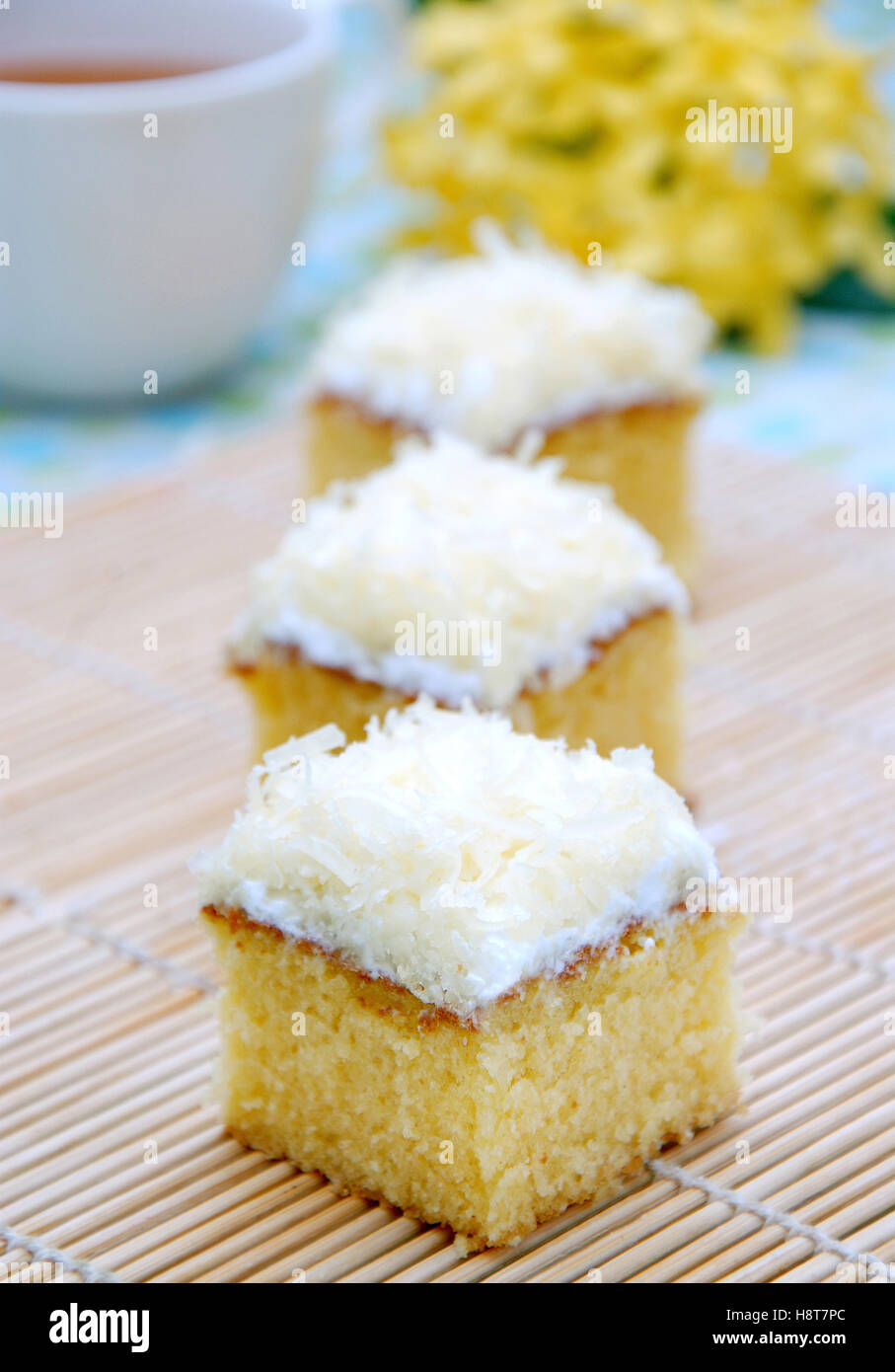 cake with cheese as a toping, with a cup of hot tea as a background Stock Photo